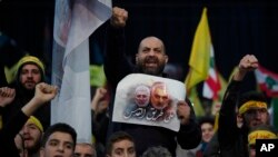 Supporters of Hezbollah leader Sayyed Hassan Nasrallah chant slogans in a southern suburb of Beirut, Lebanon, Jan. 5, 2020, following the U.S. airstrike in Iraq that killed Iranian Revolutionary Guard Gen. Qassem Soleimani. 