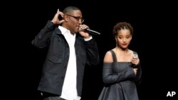 FILE - George Tillman Jr., left, director of the upcoming film "The Hate U Give," and cast member Amandla Stenberg discuss the film during the 20th Century Fox presentation at CinemaCon 2018, the official convention of the National Association of Theatre Owners, at Caesars Palace in Las Vegas, April 26, 2018.