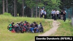 Police escorting migrants from temporary migrant camp Vucjak near Bihac, October 15, 2019.