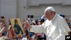Pope Francis arrives for his weekly general audience in St. Peter's Square, at the Vatican, June 12, 2019. 