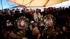 Pictures of Afghan journalist Sardar Ahmad of Agence France-Presse (R) and his wife are placed on their graves in Kabul March 23, 2014.