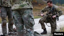 FILE - Soldiers from Denmark prepare for taking part in the European Best Sniper Squad Competition at the U.S. military base in Grafenwoehr, Germany, Oct. 26, 2016.