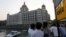 FILE - Tourists are seen in front of the Taj Mahal hotel, which was one of the targets of the Nov. 26, 2008 attacks, in Mumbai April 10, 2015. 