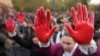 Protesters shout slogans with red paint on thire hands symbolizing blood, demanding arrests, two days after a concrete canopy collapsed at a railway station in Novi Sad, killing 14 people and injuring three, during a protest in Belgrade, Nov. 3, 2024. 