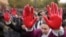 Protesters shout slogans with red paint on thire hands symbolizing blood, demanding arrests, two days after a concrete canopy collapsed at a railway station in Novi Sad, killing 14 people and injuring three, during a protest in Belgrade, Nov. 3, 2024. 
