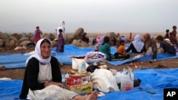 Displaced Iraqis from the Yazidi community settle at a camp at Derike, Syria, Aug. 10, 2014.