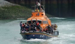 A group of people thought to be migrants are brought in to Dover onboard a lifeboat following a small boat incident in the Channel, in Kent, England, July 4, 2021.