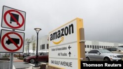 An Amazon sign stands in a parking lot outside of an Amazon warehouse as the outbreak of the coronavirus disease (COVID-19) continues in the Staten Island borough of New York U.S., May 1, 2020.