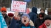 RUSSIA – Truck driver holding a sign "Putin is war and poverty" during a protest in St.Petersburg, Feb. 6, 2016