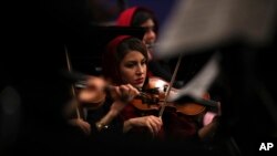 An Iranian musician plays the violin while performing pieces by 19th-century Russian composers in Tehran Symphony Orchestra at Unity Hall, in Tehran, Iran, July 3, 2019.