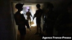 French soldiers of the Barkane operation seek protection in a shelter during explosions at the Gao army base in Mali, Dec. 5, 2021. 