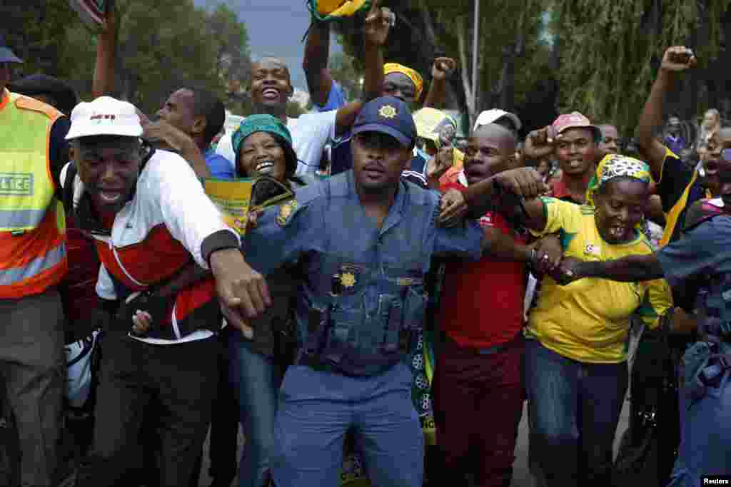 Mourners gather behind police cordons after being denied entry to the site where former South African President Nelson Mandela was lying in state in Pretoria.