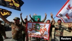 Shiite Popular Mobilization Forces (PMF) celebrate on the outskirts of Kirkuk, Iraq, Oct. 17, 2017. 