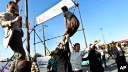 Men prevent execution of convict after being pardoned by family of policeman he murdered, Mashhad, northeastern Iran, May 8, 2013.