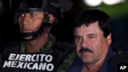 Mexican drug lord Joaquin "El Chapo" Guzman, right, is escorted by soldiers and marines to a waiting helicopter, at a federal hangar in Mexico City, Jan. 8, 2016. 