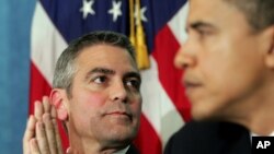 US actor George Clooney (L) and Barack Obama (R),listen during the National Press Club Newsmaker's Program. (FILE)
