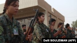 SYRIA -- Fighters from the Syrian Democratic Forces (SDF) attend the funeral of four fellow fighters in the northeastern city of Qamishli on September 14, 2018.