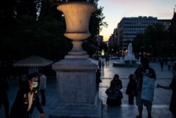 A man wearing a mask to protect against the coronavirus walks in Syntagma square in central Athens, on May 5, 2020.