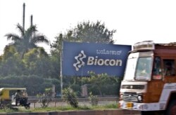 FILE - Traffic moves outside the main premises of Biocon, an Indian biotech company, in Bangalore, India, Dec. 17, 2010.