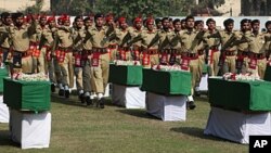 Pakistan army soldiers attend funeral ceremony of Saturday's NATO attack victims in Peshawar, Pakistan, November 27, 2011.