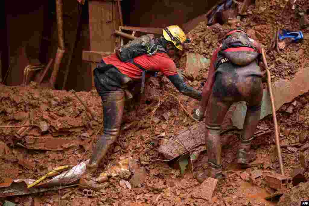 Firefighters search for missing persons after a landslide in Vila Bernadete, Belo Horizonte, Minas Gerais state, Brazil.