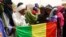 People seeking refuge from Tuareg separatist rebel group MNLA display a Malian flag in a military camp in the northern town of Kidal, July 17, 2013. 