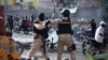 Members of the Departmental Law Enforcement Units secure an area after civilians and members of the National Police clashed with gangs, in Port-au-Prince, Haiti, Feb. 23, 2025. 