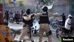 Members of the Departmental Law Enforcement Units secure an area after civilians and members of the National Police clashed with gangs, in Port-au-Prince, Haiti, Feb. 23, 2025. 