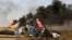 Palestinian protesters take cover during clashes with Israeli troops along Gaza's border with Israel, east of Khan Younis, Gaza Strip, April 5, 2018. A new round of protests along the border is expected Friday.