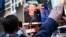 FILE - Facebook Inc. CEO Mark Zuckerberg is seen on a screen televised in New York from the company's headquarters in Menlo Park, California.