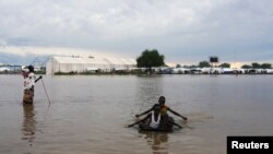 Children play in the floodwaters at the airstrip after the River Nile broke the dykes in Pibor, Greater Pibor Administrative Area, South Sudan, Oct. 6, 2020.