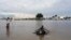 Children play in the floodwaters at the airstrip after the River Nile broke the dykes in Pibor, Greater Pibor Administrative Area, South Sudan, Oct. 6, 2020.