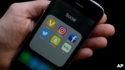 This June 16, 2017 photo shows social media app icons on a smartphone held by an Associated Press reporter in San Francisco. 