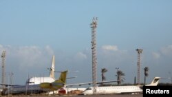FILE - Planes are seen at Mitiga Airport in Tripoli, Libya, Dec. 12, 2019.