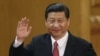 New Communist Party General Secretary Xi Jinping waves in Beijing's Great Hall of the People Nov. 15, 2012.