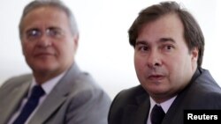 Congressman Rodrigo Maia (R), the new House Speaker, looks on near Brazil's Senate President Renan Calheiros, during a meeting with Brazil's interim President Michel Temer at the Planalto Palace in Brasilia, Brazil, July 14, 2016.