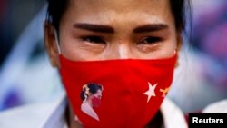 A woman cries during a prayer ceremony for those who died in Myanmar during anti-coup protests, in front of the U.N. building in Bangkok, Thailand March 4, 2021. 