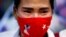 A woman cries during a prayer ceremony for those who died in Myanmar during anti-coup protests, in front of the U.N. building in Bangkok, Thailand.
