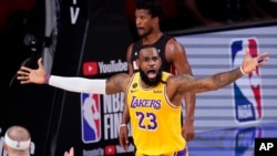 FILE - Los Angeles Lakers forward LeBron James reacts during the first half in Game 4 of basketball's NBA Finals, Oct. 6, 2020, in Lake Buena Vista, Fla.