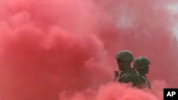 FILE - South Korea and U.S. Marines stand in smoke during the 66th Incheon Landing Operations Commemoration ceremony in Incheon, South Korea, Sept. 9, 2016.