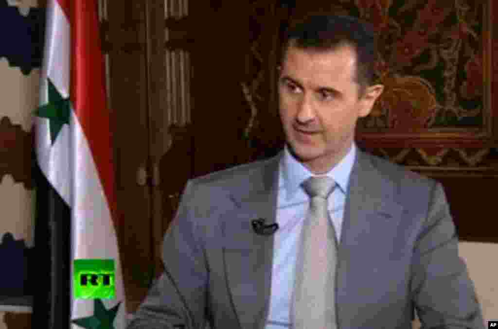 Syrian President Bashar Assad speaks with English-language television channel Russia Today. He vowed to "to live in Syria and die in Syria", declaring in an interview broadcast Thursday, Nov. 8