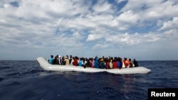 Off the Libyan coast, 104 sub-Saharan Africans in a rubber dinghy await rescue. The charity Migrant Offshore Aid Station provided this courtesy photo Oct. 4, 2014. 