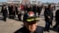 A delegate to the Chinese People's Political Consultative Conference wears a cap with the words "Chinese navy guardian of the Spratly Islands" as he arrives at Beijing's Great Hall of the People for a plenary session, March 9, 2015. 