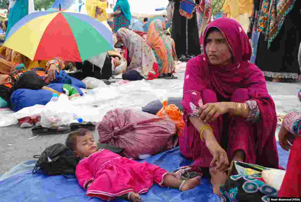 ایک بچی دھرنے کے شور و غوغا سے بے خبر سو رہی ہے۔