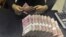 FILE - A clerk counts 100 Chinese yuan banknotes at a branch of China Merchants Bank in Hefei, Anhui province, April 20, 2015.