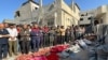 Palestinians pray over bodies of relatives, killed in an overnight Israeli airstrike, in Beit Lahia the northern Gaza Strip on Oct. 27, 2024. 