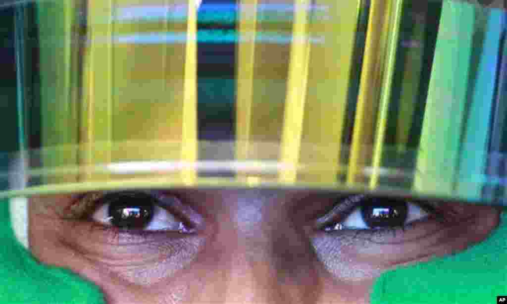 McLaren Mercedes driver Lewis Hamilton, from the United Kingdom, waits inside his car before the start of the second free practice ahead of the Brazilian F1 Grand Prix at the Interlagos racetrack in Sao Paulo, Brazil, Friday, Nov. 25, 2011. The Brazilian
