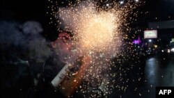 An anti-government demonstrator with a Spiderman mask fires a home-made mortar during a protest demanding Nicaraguan President Daniel Ortega and his wife, Vice President Rosario Murillo, stand down, in Managua on May 26, 2018.