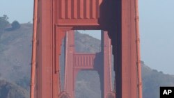 FILE - Automobile traffic flows over the Golden Gate Bridge in San Francisco, Sept. 19, 2013. 