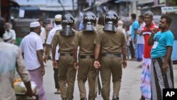 Sri Lankan policeman patrol in a Muslim neighborhood before Friday prayers in Colombo, Sri Lanka, April 26, 2019.